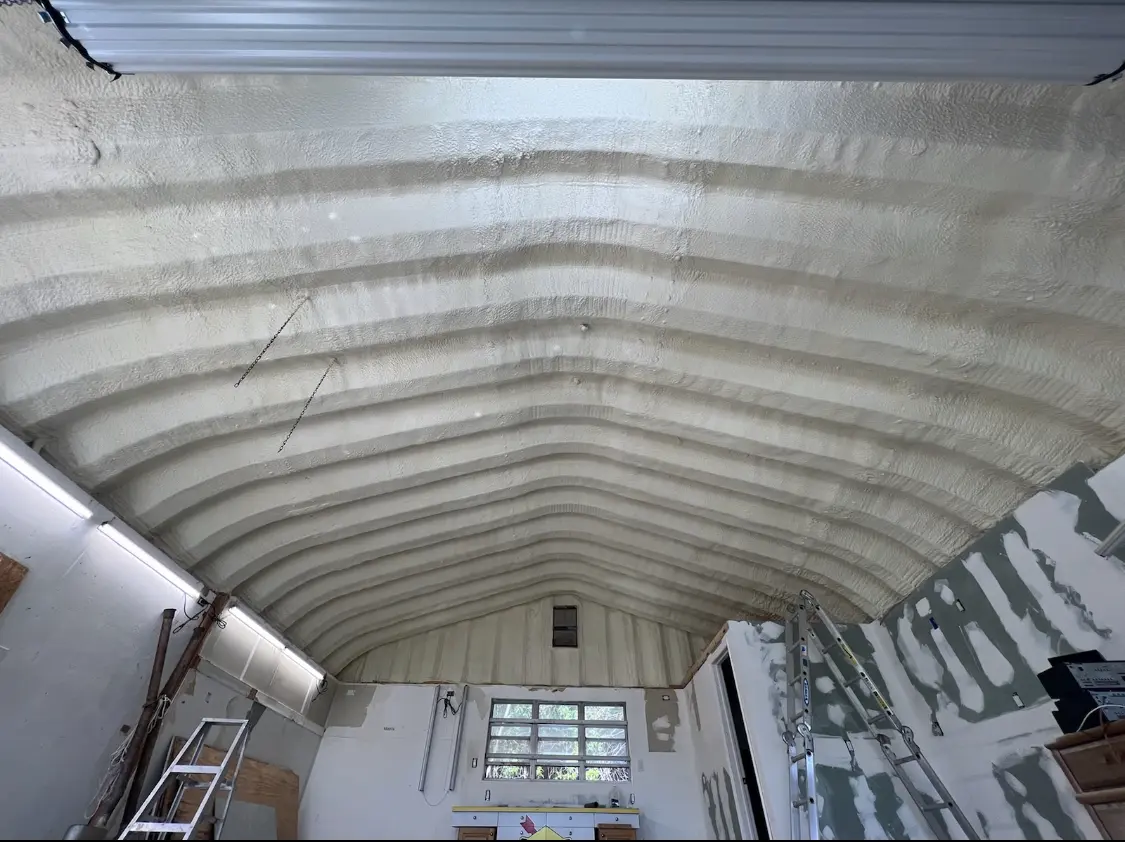 Spray polyurethane foam applied to the underside of a metal roof deck in East Bridgewater